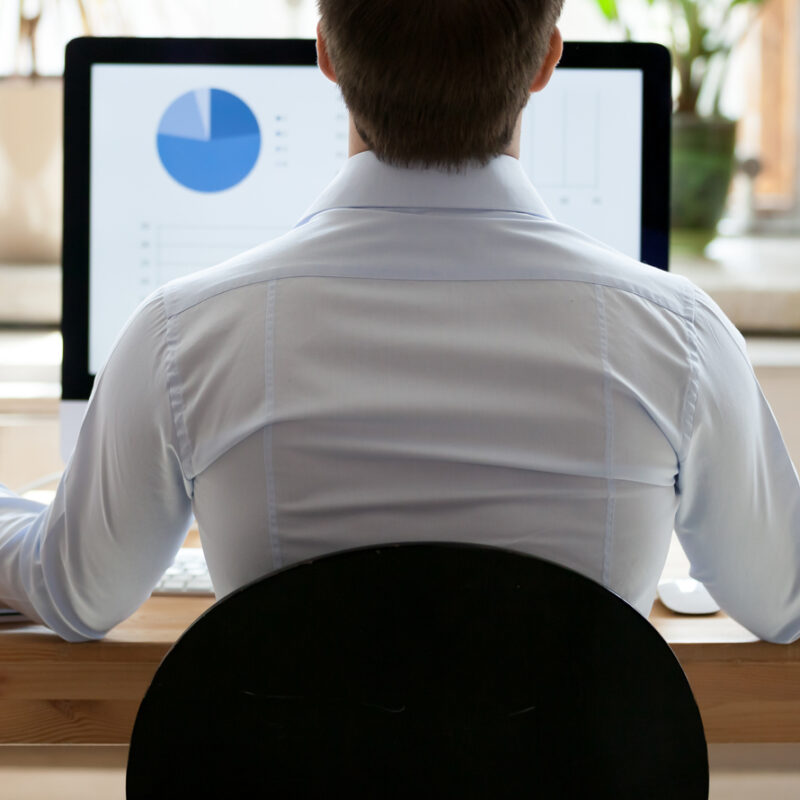 Man sitting at desk in a mindful pose with hands out