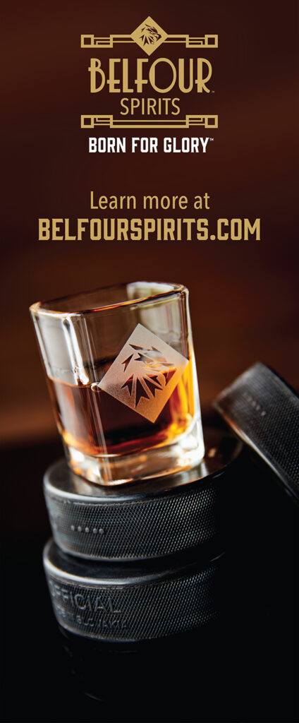 Seven foot pop-up banner featuring the Belfour shot glass on a stack of pucks on a dark wood background