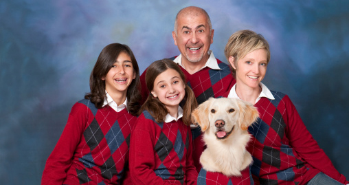 Humorous family portrait with golden retriever dog all in cardigans.